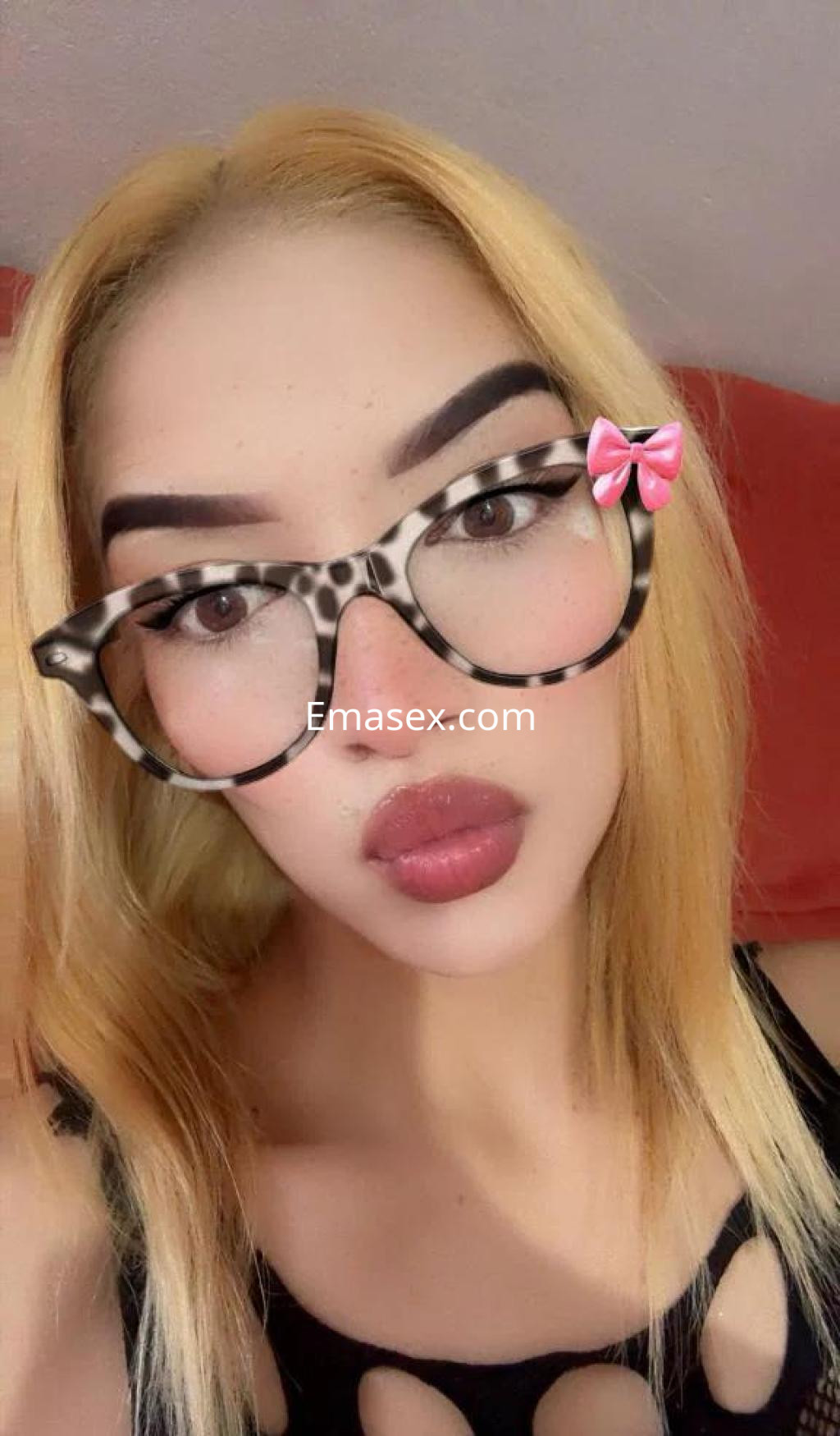 Puta con cabello rubio y gafas de acetato, posa con una expresión seductora en Coruña.