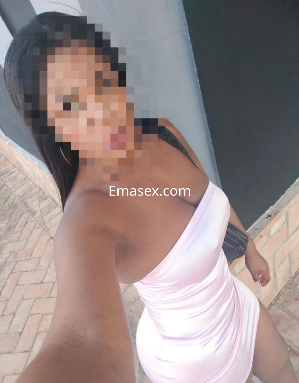 Escort en Bilbao luciendo un vestido corto de color rosa que destaca su figura, con cabello largo y lacio.