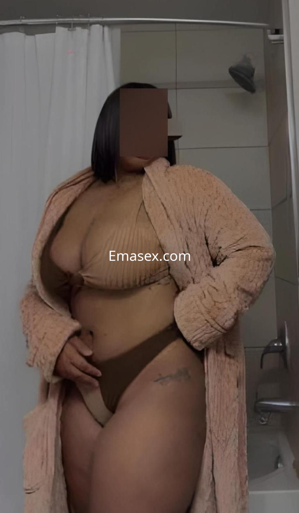 La puta está en un baño, con un conjunto de lencería marrón y una bata de felpa, mostrando confianza en Valladolid.