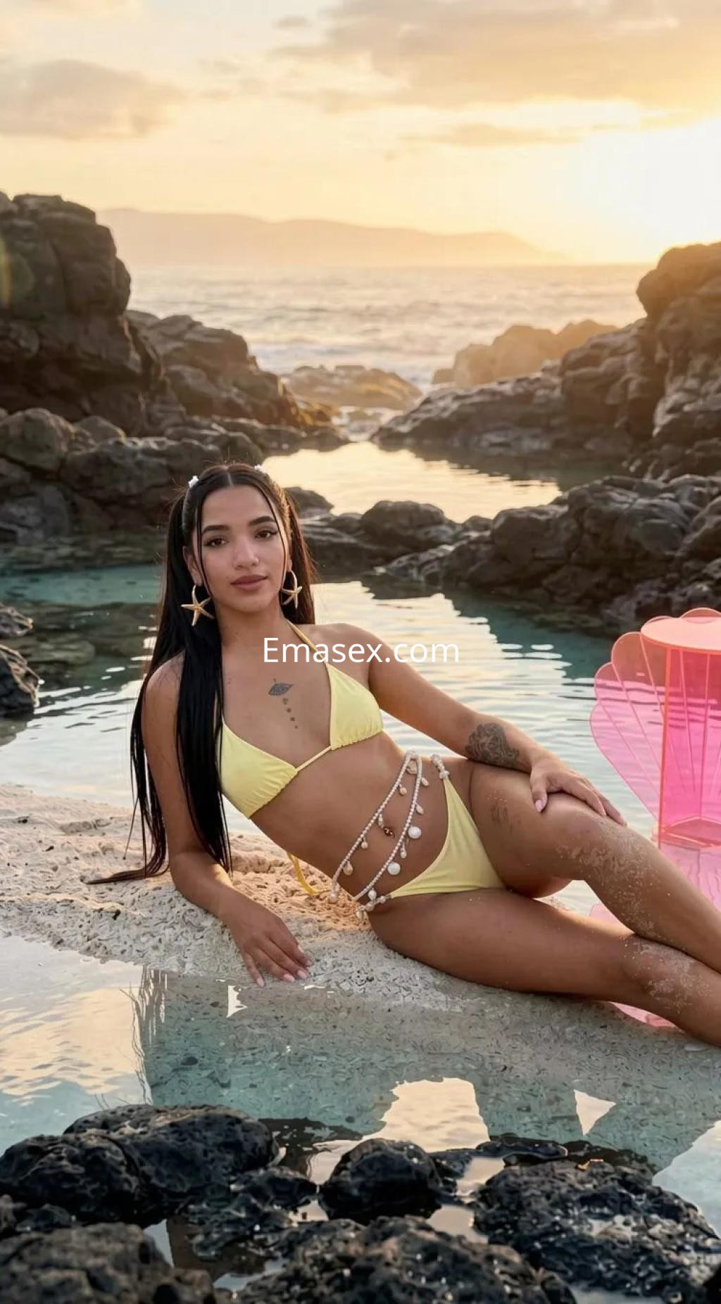 Escort en Barcelona, luciendo un bikini amarillo con detalles en la cintura, posando en una playa al atardecer.