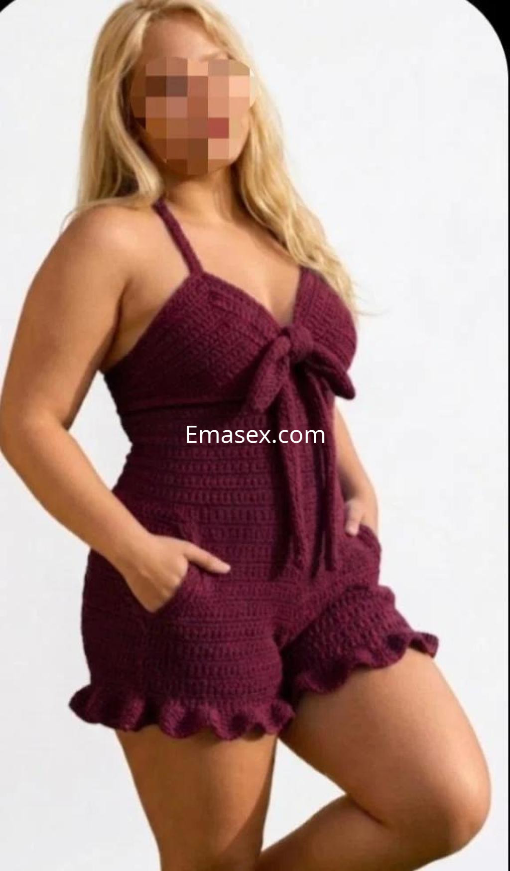 Escort en Salamanca luciendo un conjunto de tirantes color burdeos, con un diseño de nudos y volantes.