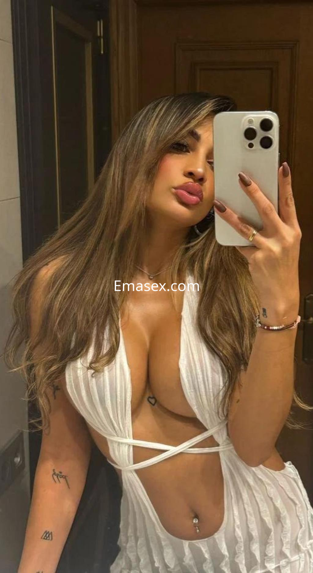 La puta se retrata en el espejo con un vestido blanco ajustado, mostrando su figura en Lleida.