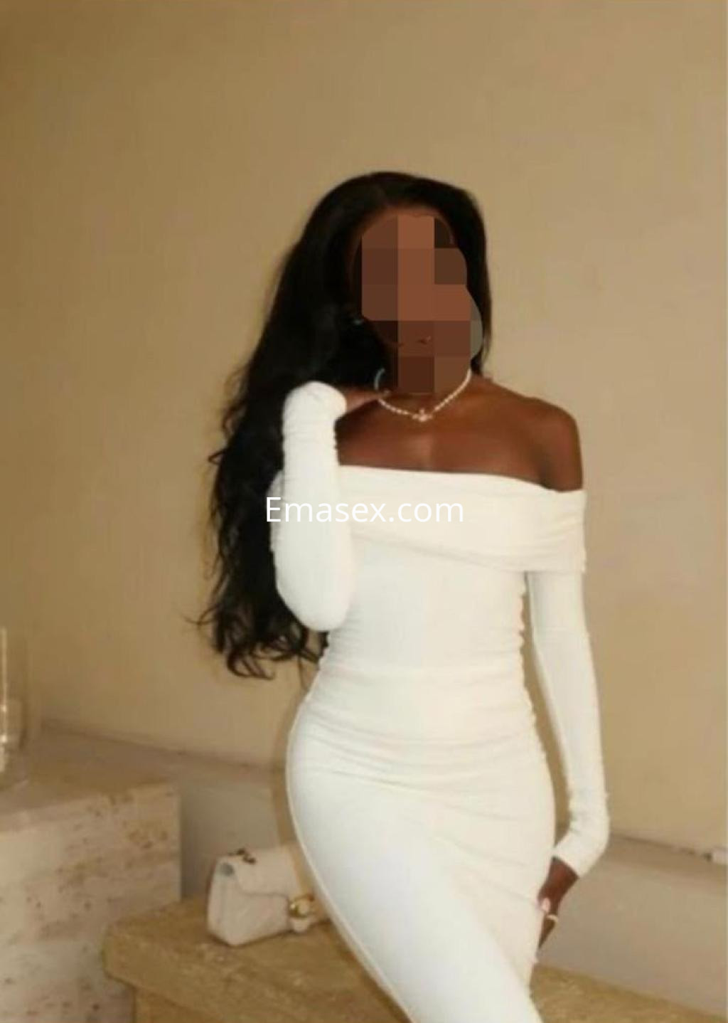 Puta en Pamplona luce un vestido blanco ajustado de manga larga, con cabello largo y ondulado.