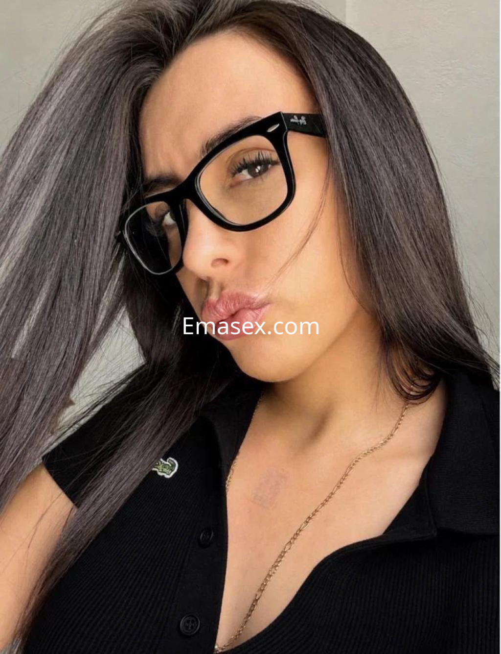 Puta en Las Palmas con cabello largo y lacio, usando gafas oscuras y una blusa negra ajustada.