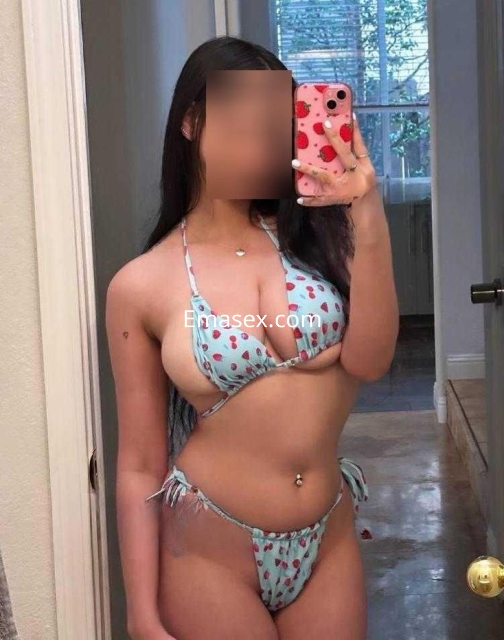 Puta de Lugo posando en un espejo, luciendo un bikini de tirantes azul con estampado de fresas que realza su figura.