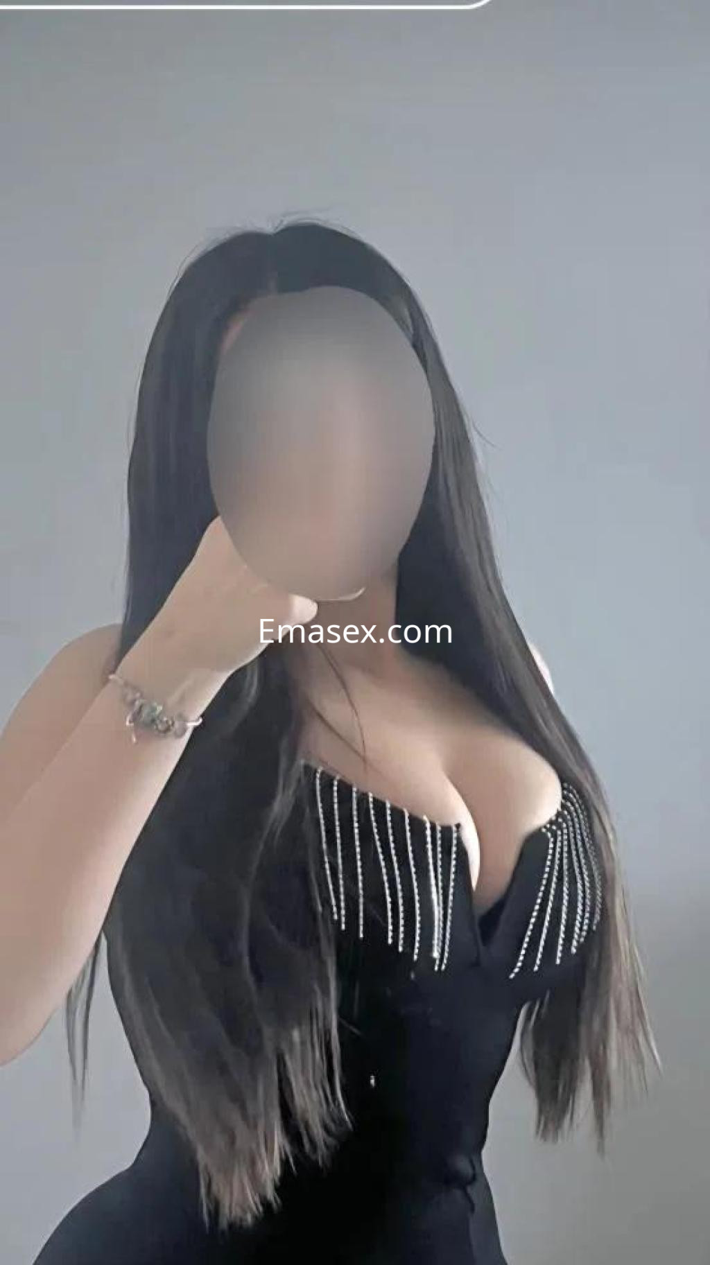 Puta con cabello largo y lacio, vestida con un vestido negro ajustado con detalles brillantes, en Cádiz.