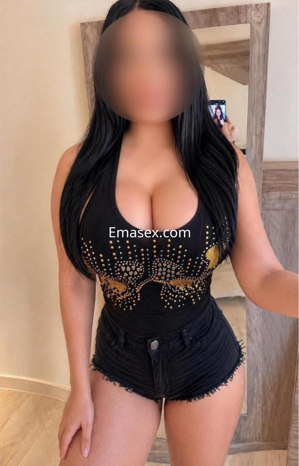 La puta aparece en Zaragoza, vistiendo un body negro con detalles brillantes y shorts de mezclilla ajustados.