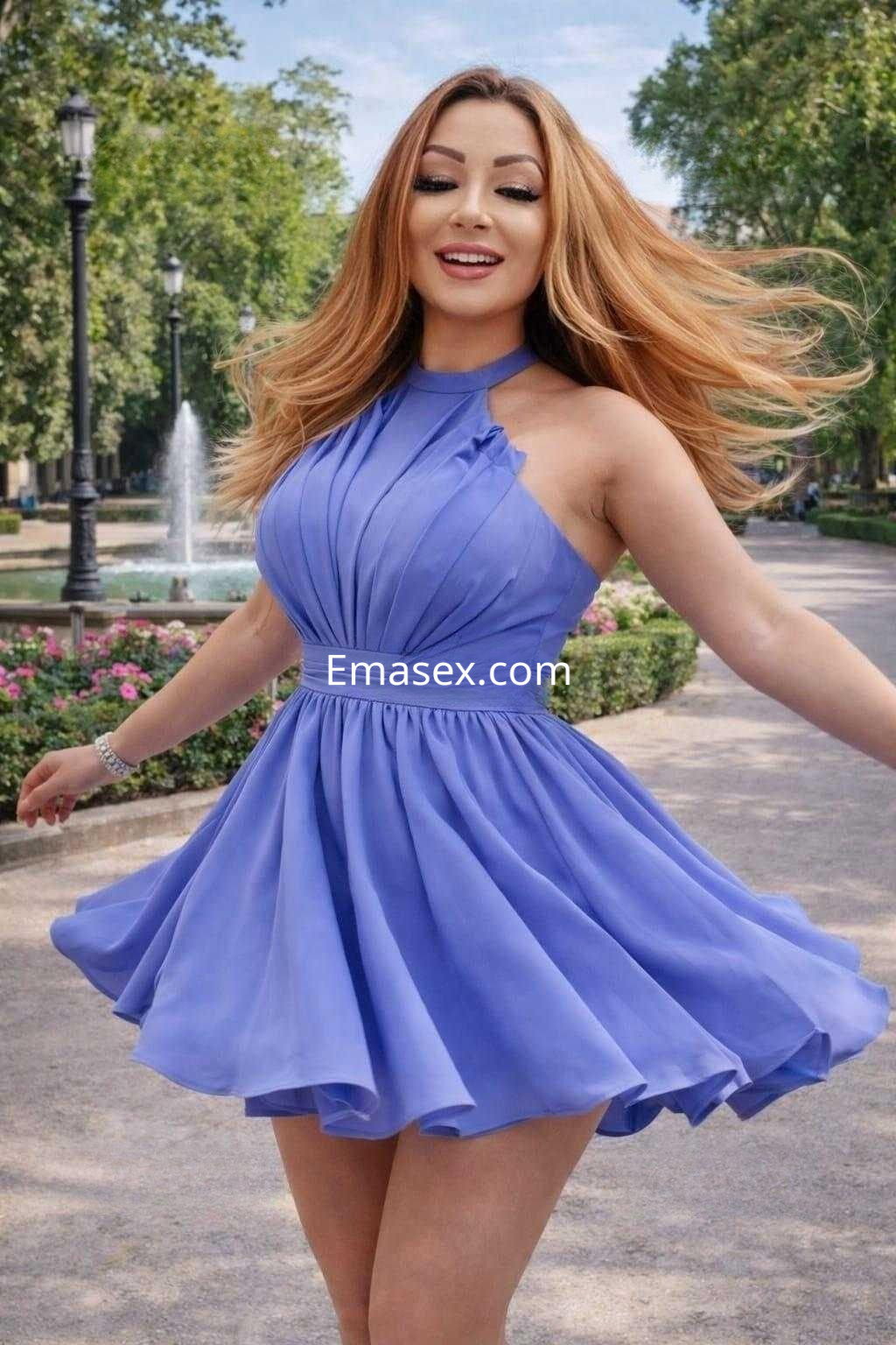 Puta con vestido azul claro girando alegremente en un parque de Castellón, rodeada de árboles y flores.